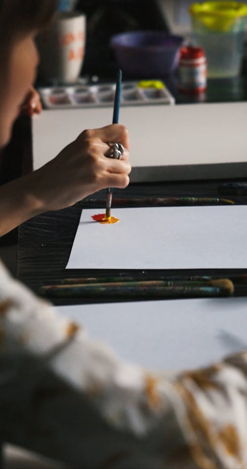 Person Painting on a Paper