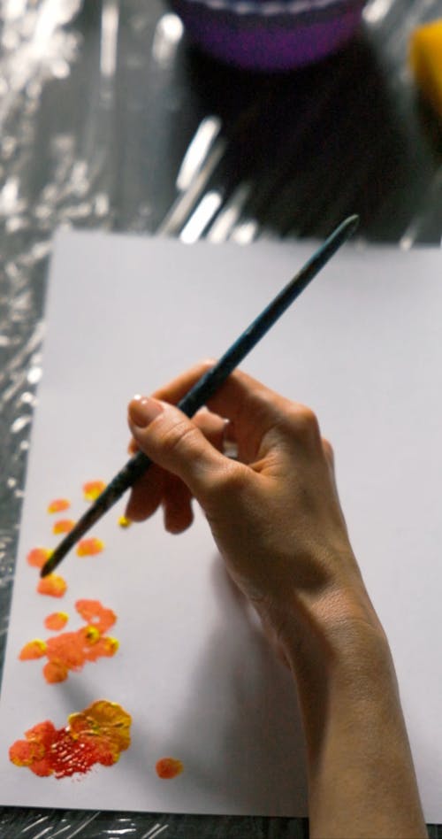 Person Painting on a Paper