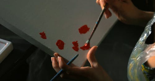 Person Painting on a Canvas