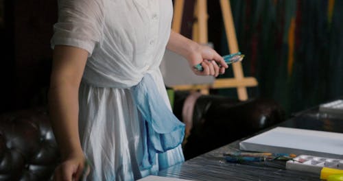 Woman holding Paintbrushes