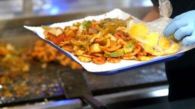 a person preparing a platter of seafood in the kitchen