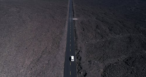 Drone Footage of a Car Driving in a Desert Road
