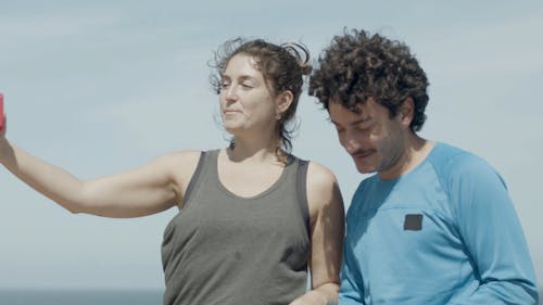 A Man and a Woman Taking a Selfie on a Windy Day