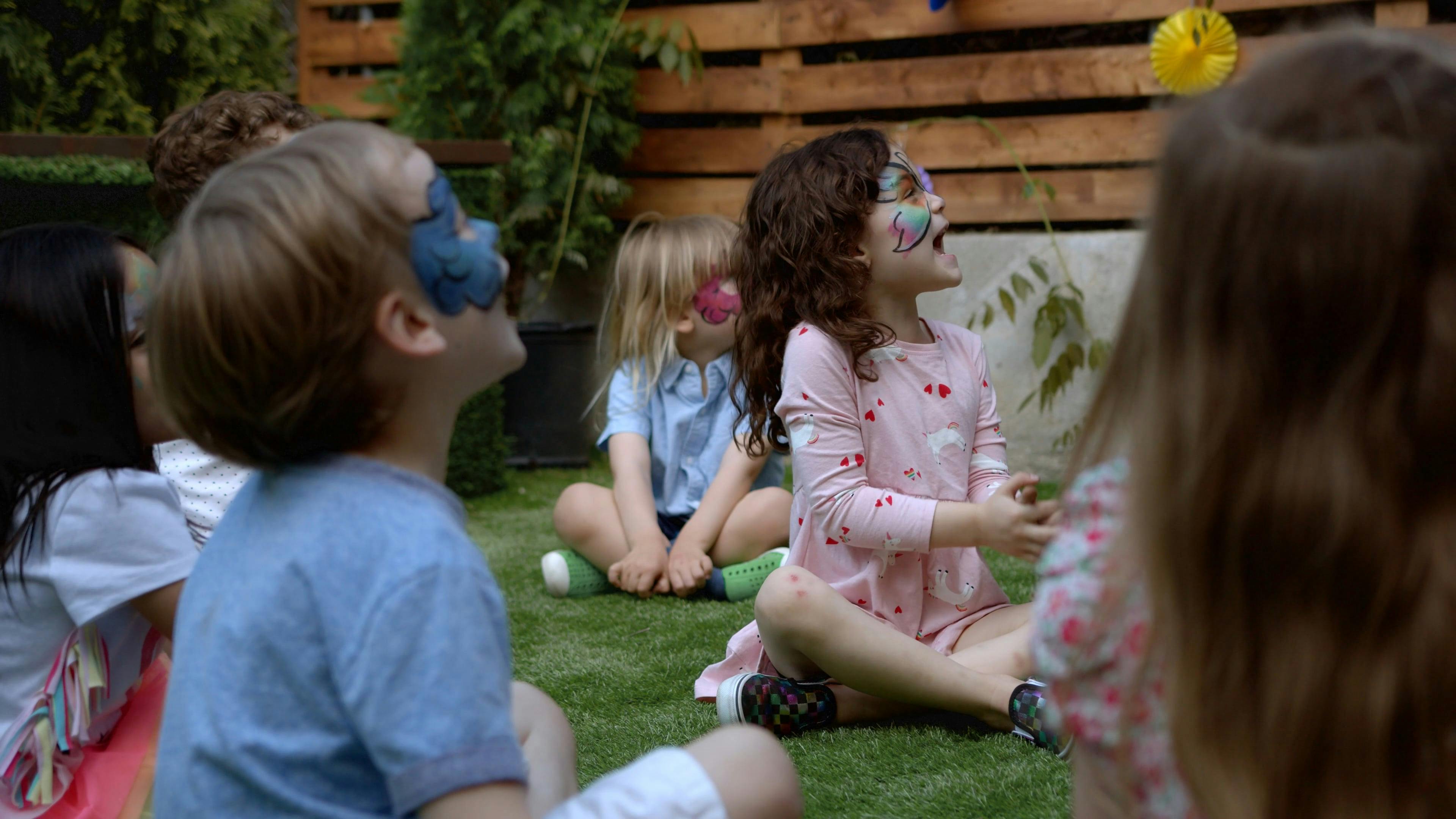 Children with Face Paint Sitting Together on the Grass · Free Stock Video