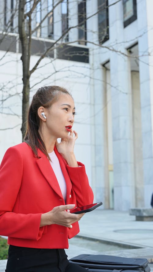 A Woman in Corporate Attire Talking in a Phone Call
