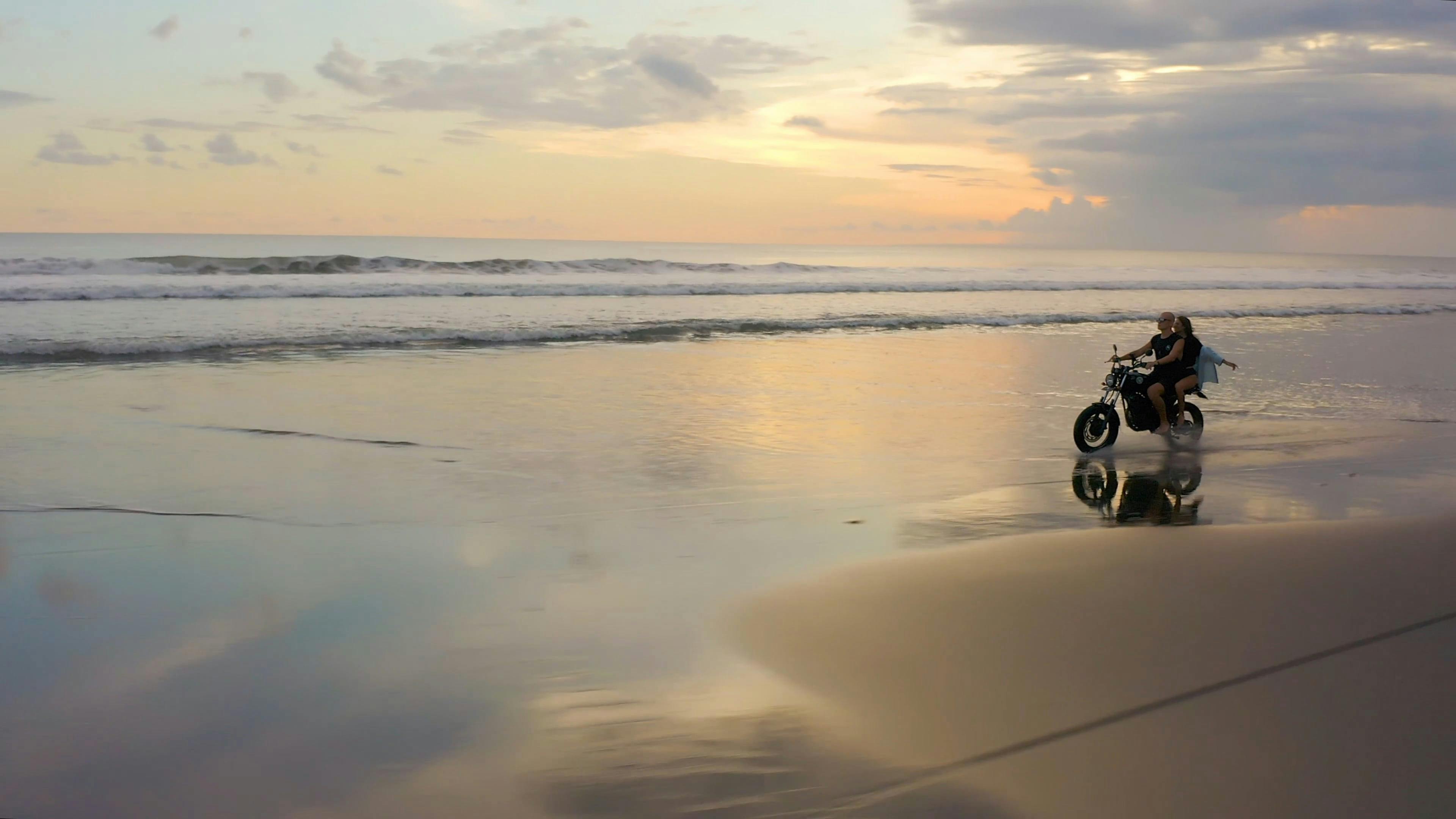 Couple Riding Motorcycle on Wet Sand Free Stock Video Footage, Royalty