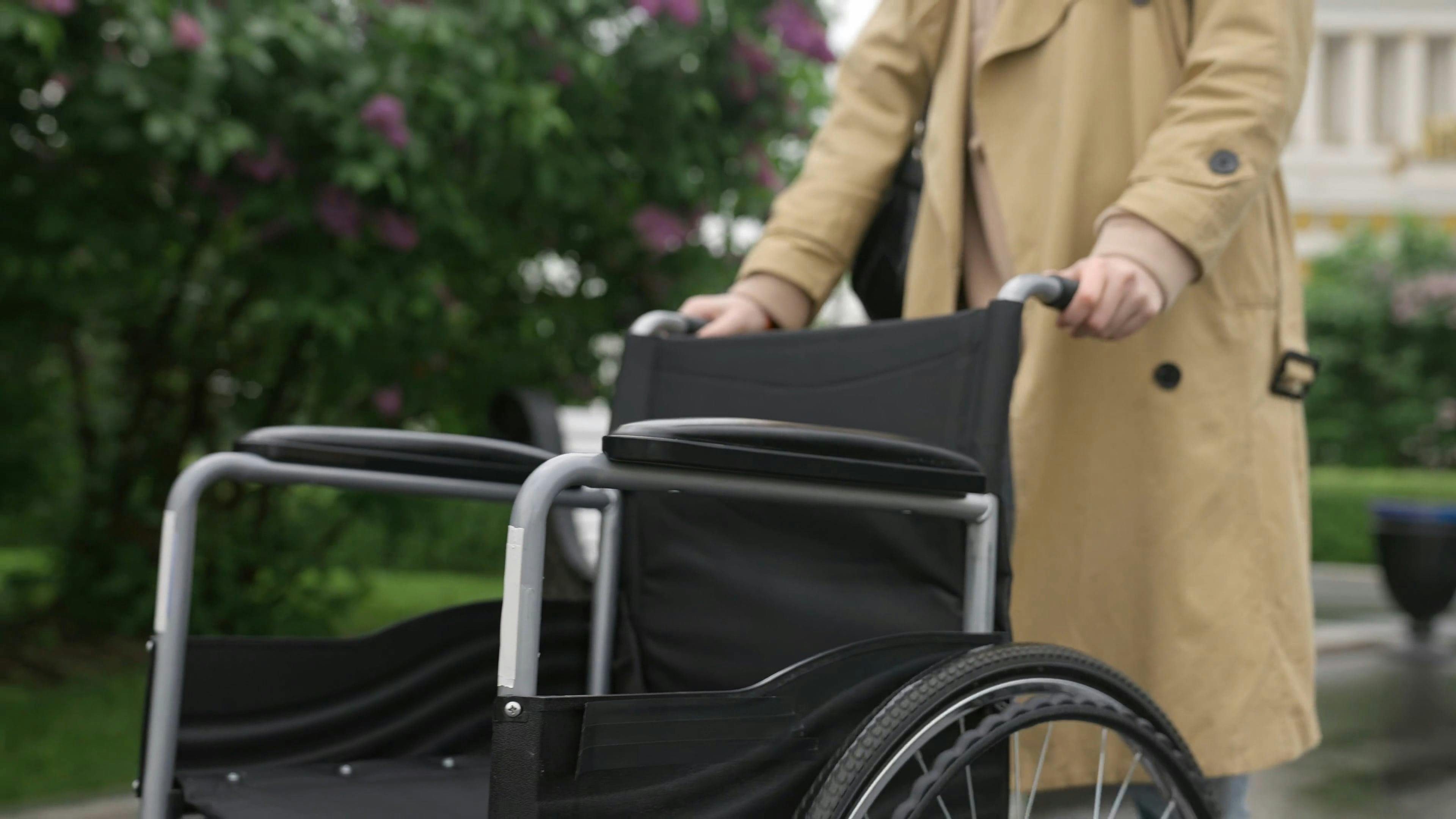 Person Pushing a Wheelchair · Free Stock Video