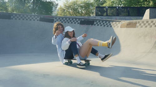 A Young Woman Having Fun at a Skate Park with a Friend