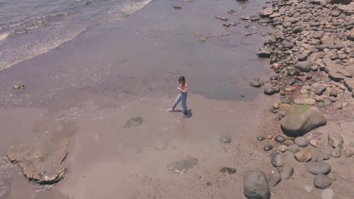 Woman Walking On Water In a Beach