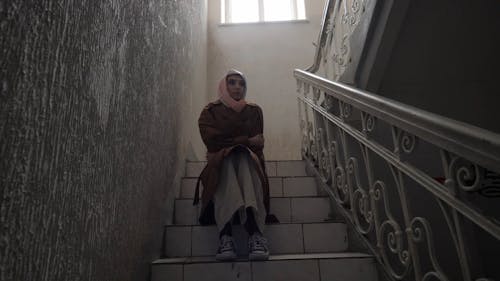 A Woman Sitting on the Stairs