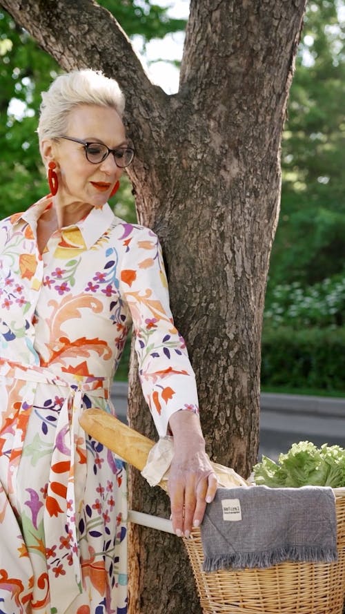 Elderly Woman Leaning Against the Tree