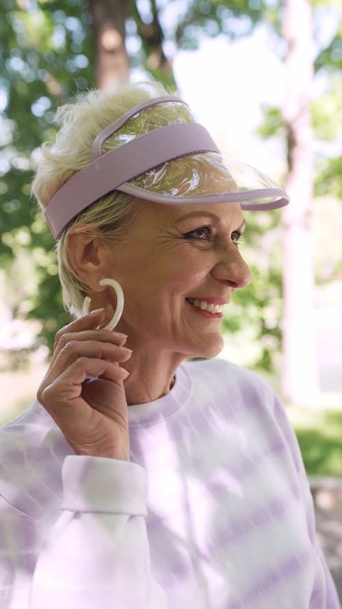 A Happy Elderly Woman Wearing a Sun Visor