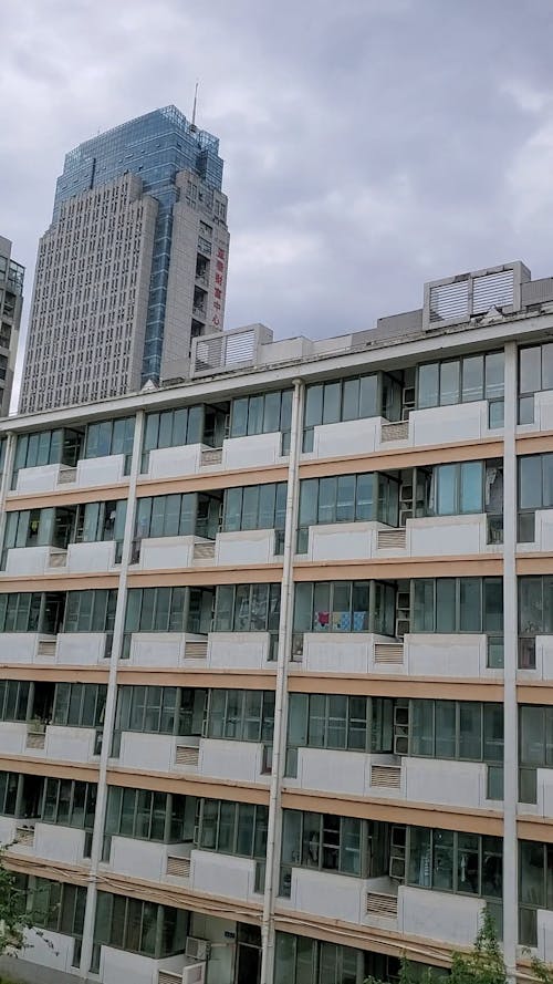 Time Lapse of White Clouds Moving above an Apartment Building