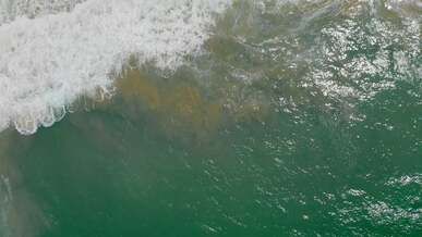 aerial footage of waves in a beach
