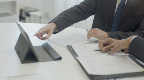 Men Working Together While Looking at a Tablet