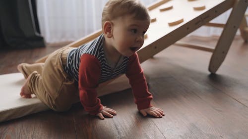 A Little Boy Crawling on the Floor