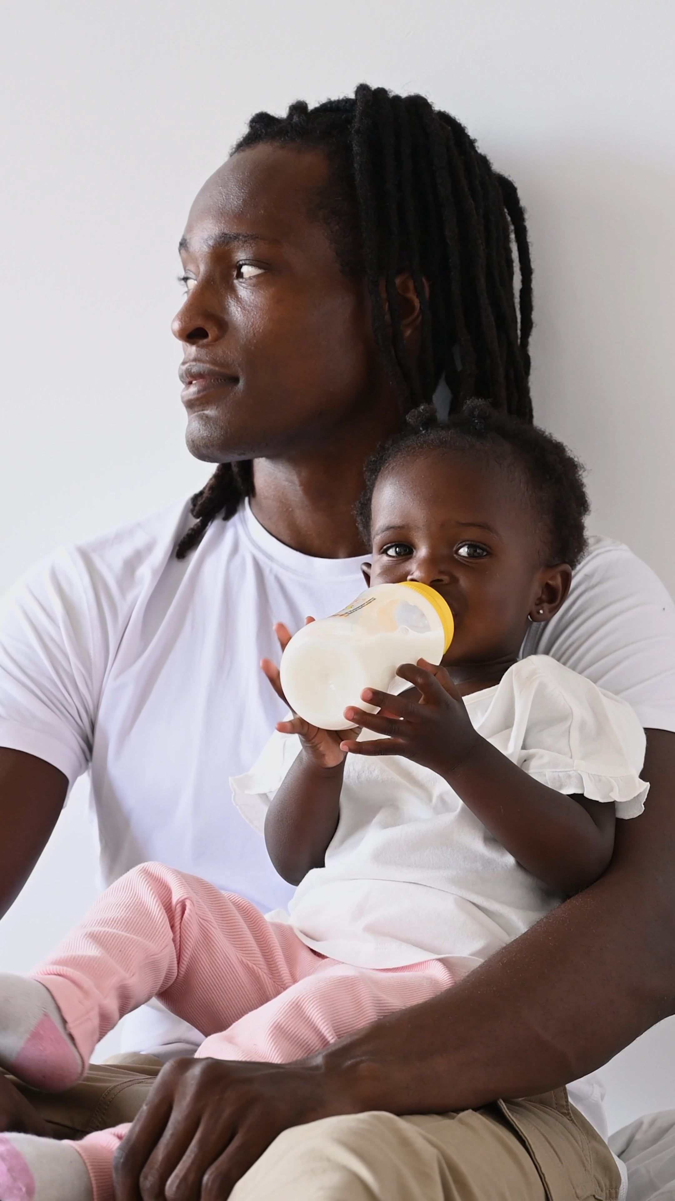 baby-drinking-milk-while-in-her-father-s-arm-free-stock-video