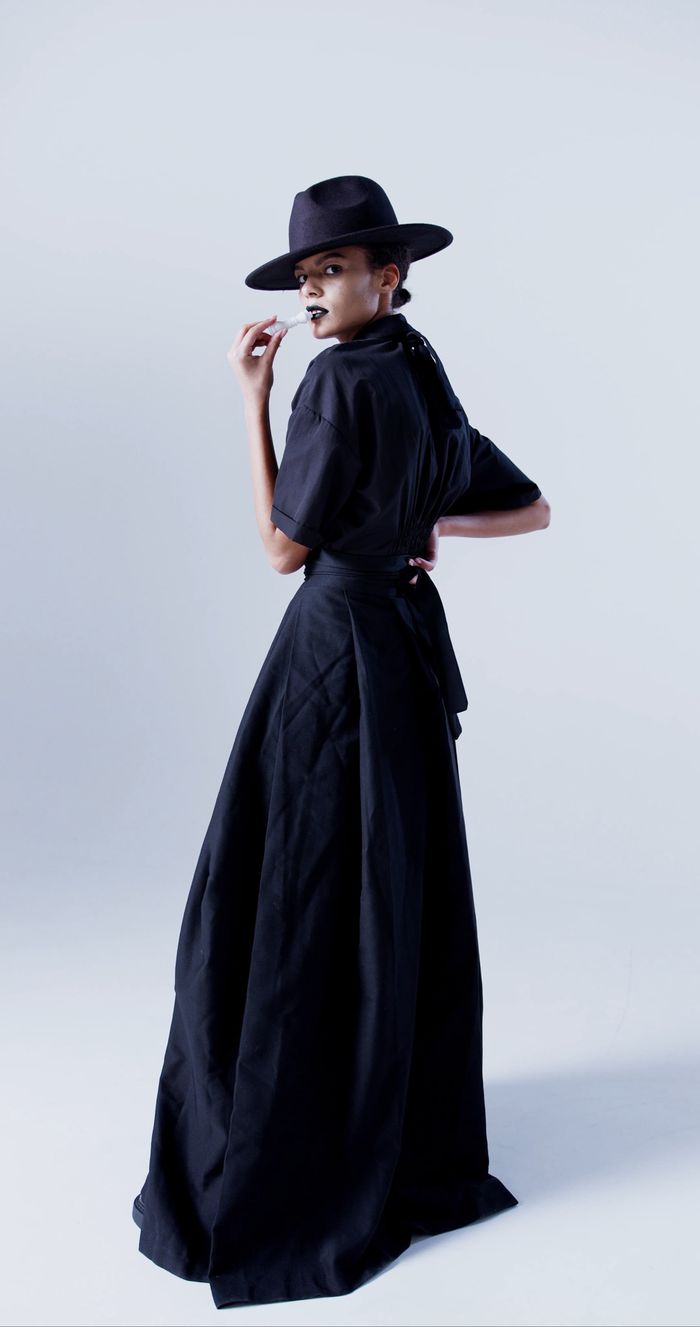 Black maxi dress with wide-brim hat, studio