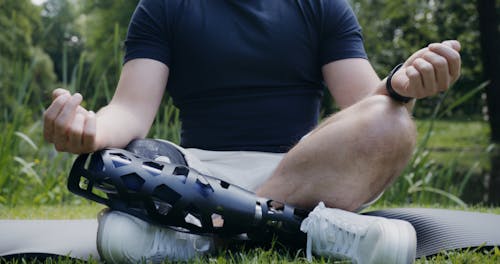 A Man With Prosthetic Leg Meditating Outdoors