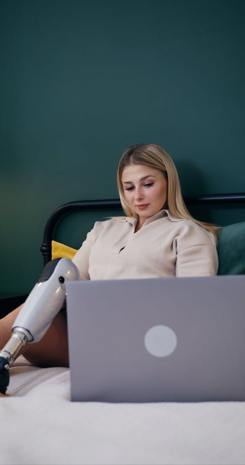 A Woman Using a Laptop while in Bed