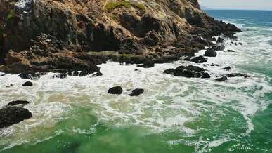 waves crashing on rock formation
