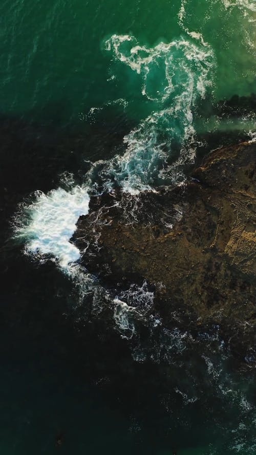 Bird's-eye View of Waves Splashing on Rocks Free Stock Video Footage ...