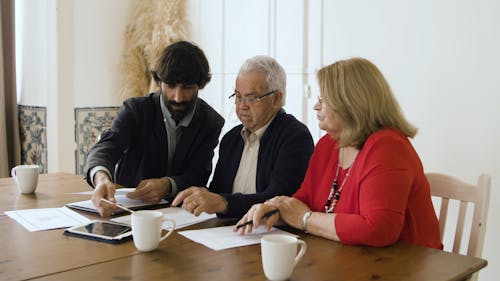 A Man Closing A Business Deal With An Elderly Couple