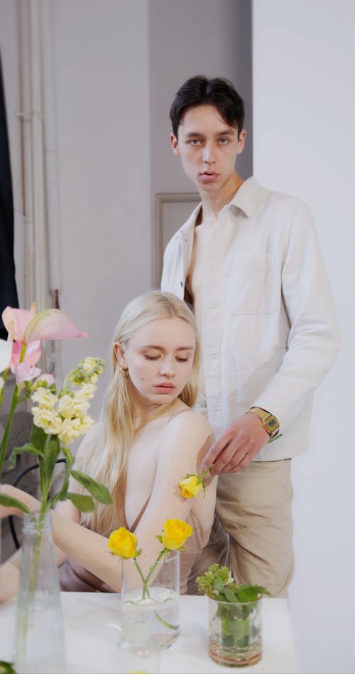 A Man Rubbing a Flower on a Woman's Arm