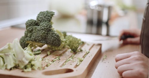 A Person Cutting a Broccoli