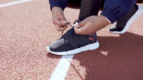 A Person Tying His Shoelace