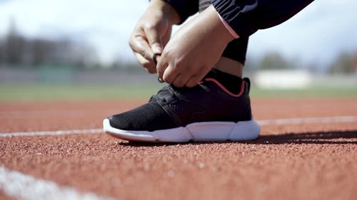 A Person Tying His Shoelace