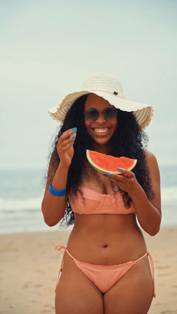 A woman in a white bikini standing on the beach Free Stock Video ...