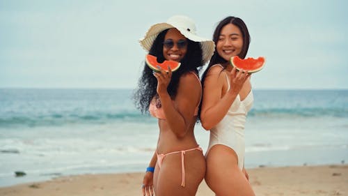 Women Holding Watermelons In the Beach