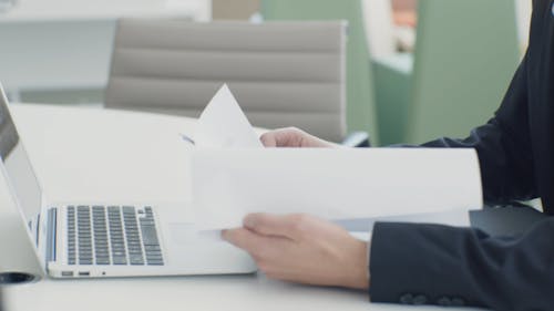 Man Working and Reading Documents Inside the Office