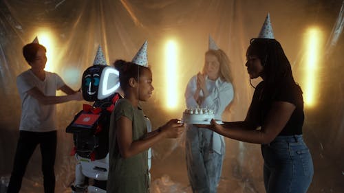 Video of Group of Friends Celebrating a Birthday with a Robot