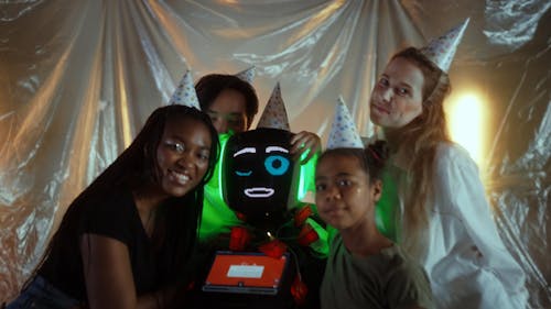Video of Friends Wearing Party Hats Along with a Companion Robot