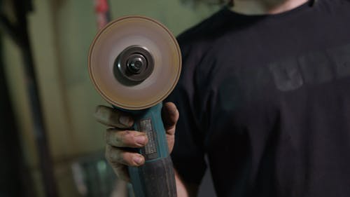 Person Holding Angle Grinder