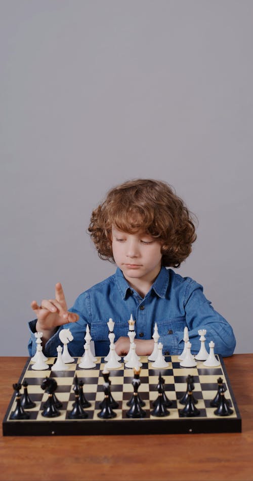 Boy Playing Chess Alone