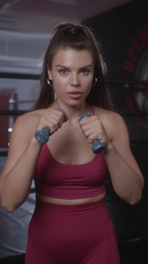 Woman Practice Punching With Dumbbells