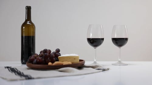 Red Wine, Cheese and Fruit on a Table