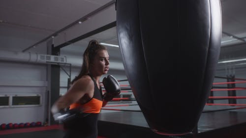 A Woman Punching a Boxing Bag
