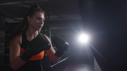A Woman Punching a Boxing Bag