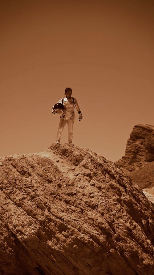 An Astronaut Standing on a Rock