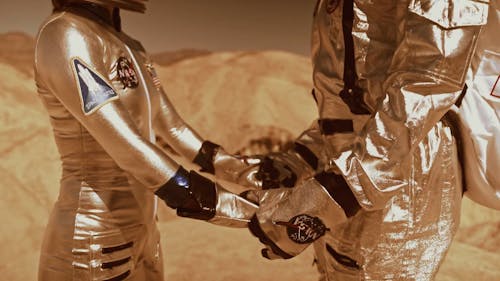Pull Out Shot of Astronauts Holding Hands on Mars