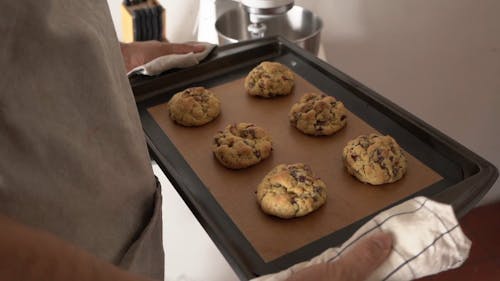 A Person Holding a Tray With Cookies
