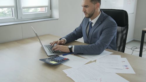 A Businessman Working on His Laptop 