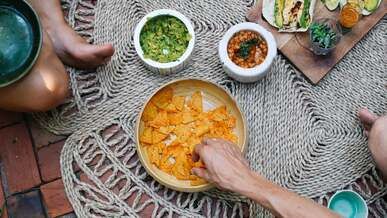 close up footage of people getting chips in a bowl