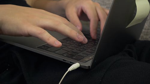 Person Typing in a Laptop