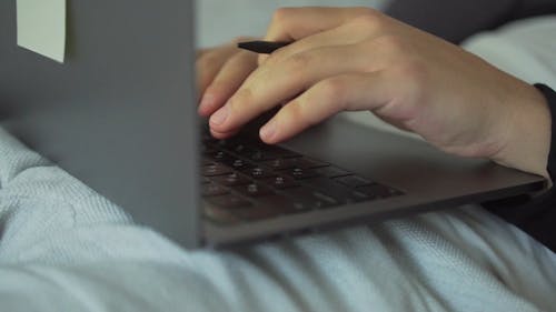 Close Up Video of a Person Typing on a Laptop