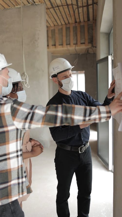 Man Presenting the House Floor Plan to the Buyers